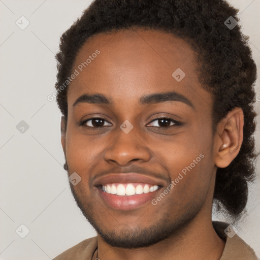 Joyful black young-adult male with short  brown hair and brown eyes