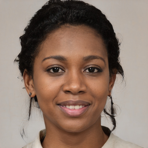 Joyful black young-adult female with medium  black hair and brown eyes