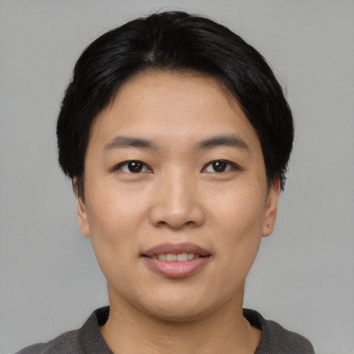 Joyful asian young-adult female with short  black hair and brown eyes