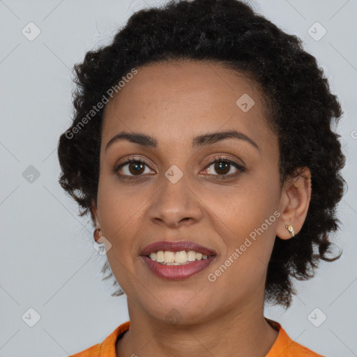 Joyful black young-adult female with short  brown hair and brown eyes