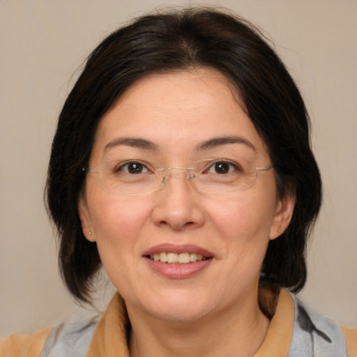 Joyful white adult female with medium  brown hair and brown eyes