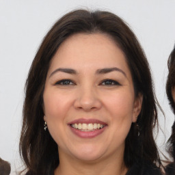 Joyful white adult female with long  brown hair and brown eyes