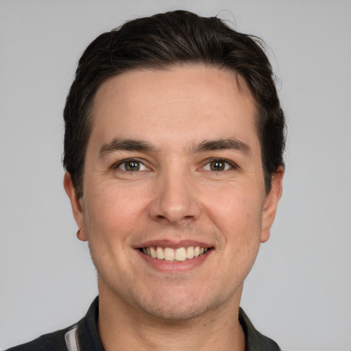 Joyful white young-adult male with short  brown hair and brown eyes