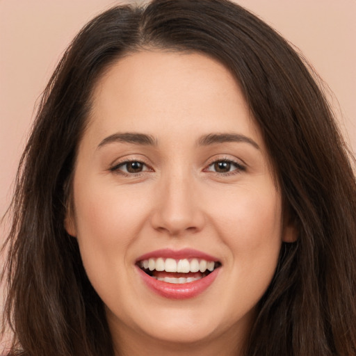 Joyful white young-adult female with long  brown hair and brown eyes