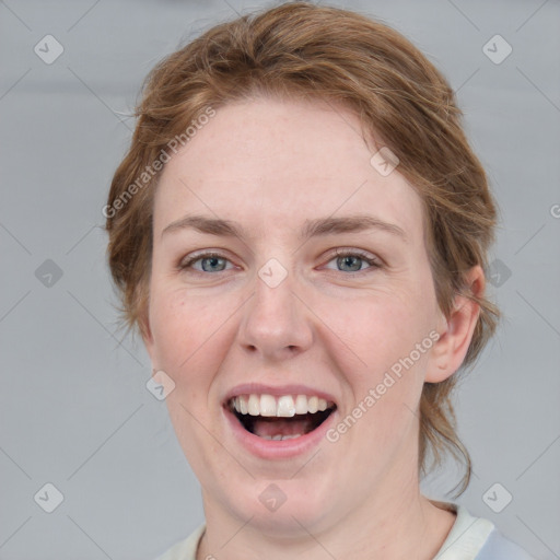 Joyful white young-adult female with medium  brown hair and blue eyes