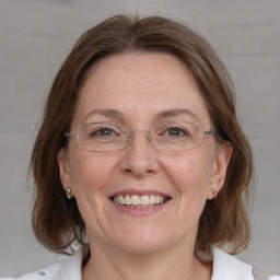 Joyful white adult female with medium  brown hair and blue eyes