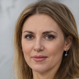 Joyful white adult female with long  brown hair and brown eyes