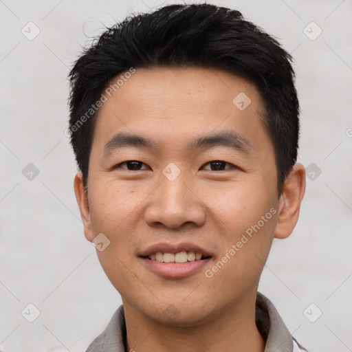 Joyful asian young-adult male with short  black hair and brown eyes