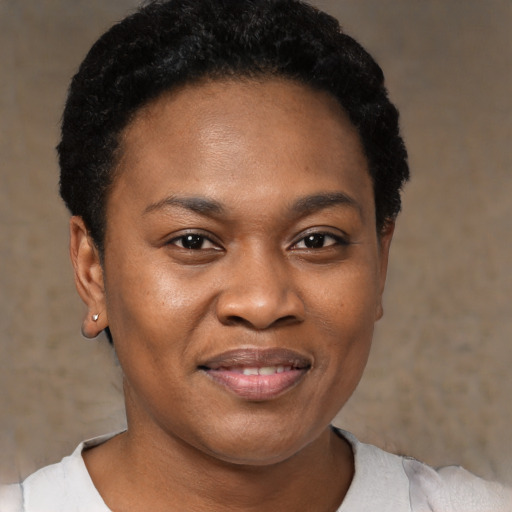 Joyful black young-adult female with short  black hair and brown eyes