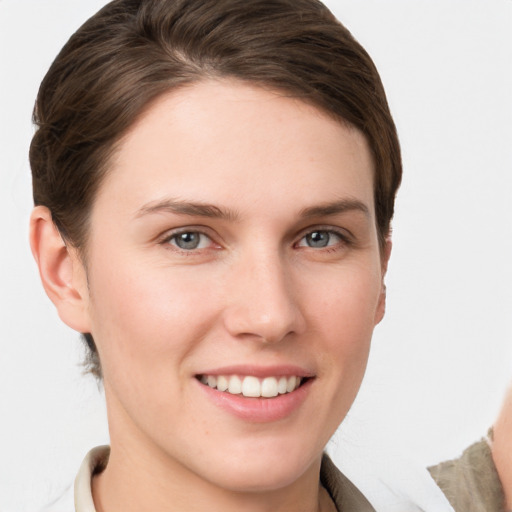 Joyful white young-adult female with short  brown hair and grey eyes