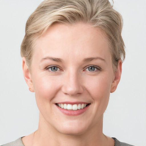 Joyful white young-adult female with short  brown hair and grey eyes