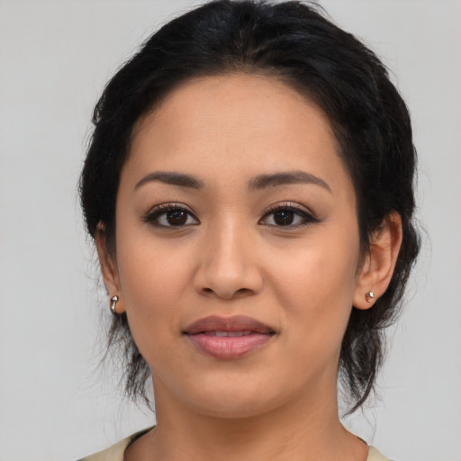 Joyful latino young-adult female with medium  black hair and brown eyes