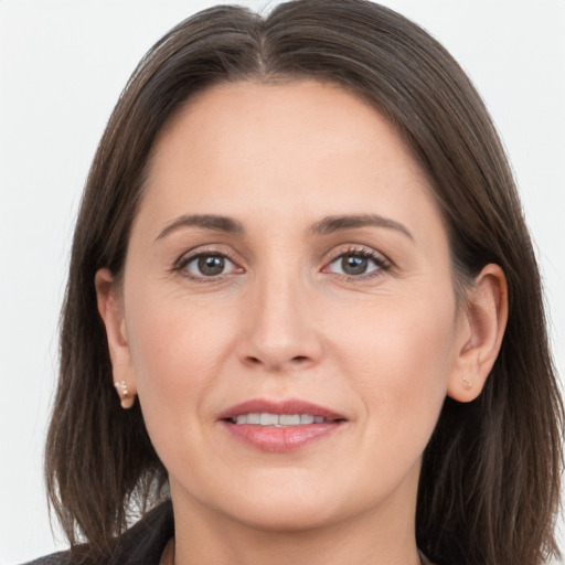 Joyful white young-adult female with long  brown hair and brown eyes