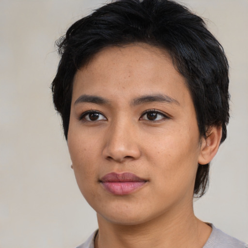 Joyful asian young-adult female with short  black hair and brown eyes