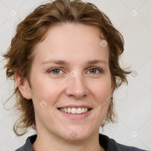 Joyful white adult female with medium  brown hair and blue eyes