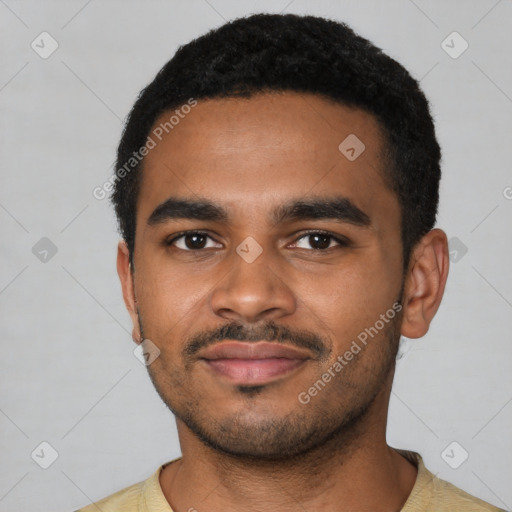 Joyful black young-adult male with short  black hair and brown eyes