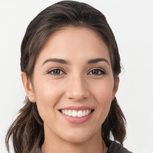 Joyful white young-adult female with medium  brown hair and brown eyes