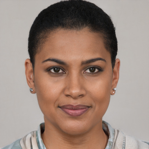 Joyful black young-adult female with short  brown hair and brown eyes