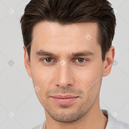 Joyful white young-adult male with short  brown hair and brown eyes