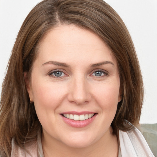 Joyful white young-adult female with medium  brown hair and grey eyes