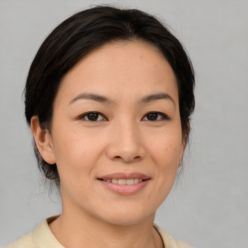 Joyful asian young-adult female with medium  brown hair and brown eyes