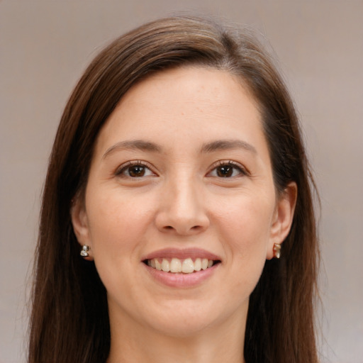 Joyful white young-adult female with long  brown hair and brown eyes