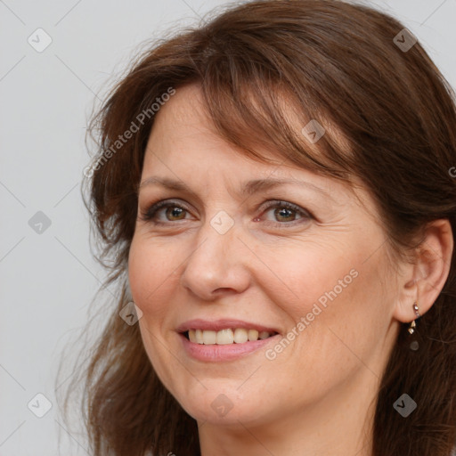 Joyful white adult female with long  brown hair and brown eyes