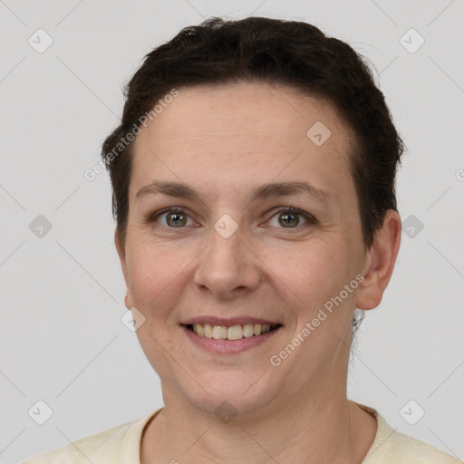 Joyful white adult female with short  brown hair and grey eyes