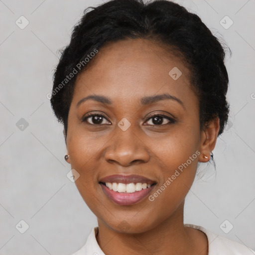 Joyful black adult female with short  black hair and brown eyes