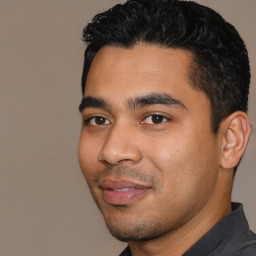 Joyful latino young-adult male with short  black hair and brown eyes