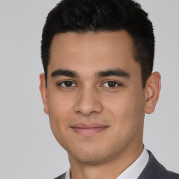 Joyful white young-adult male with short  black hair and brown eyes