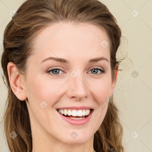 Joyful white young-adult female with long  brown hair and blue eyes