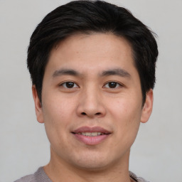 Joyful asian young-adult male with short  brown hair and brown eyes