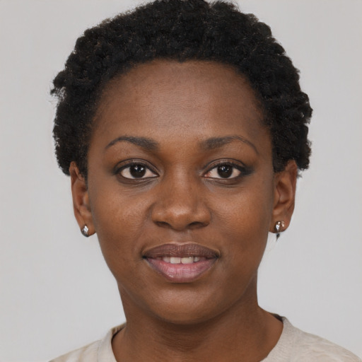 Joyful black young-adult female with short  black hair and brown eyes
