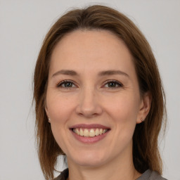 Joyful white adult female with medium  brown hair and brown eyes