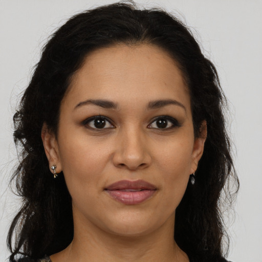 Joyful latino young-adult female with long  brown hair and brown eyes