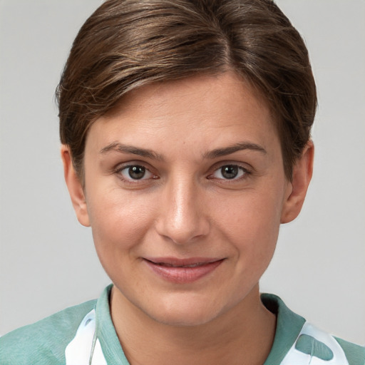 Joyful white young-adult female with short  brown hair and brown eyes