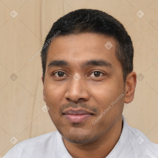 Joyful latino young-adult male with short  black hair and brown eyes