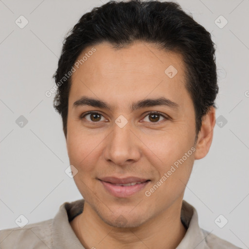 Joyful latino young-adult male with short  brown hair and brown eyes