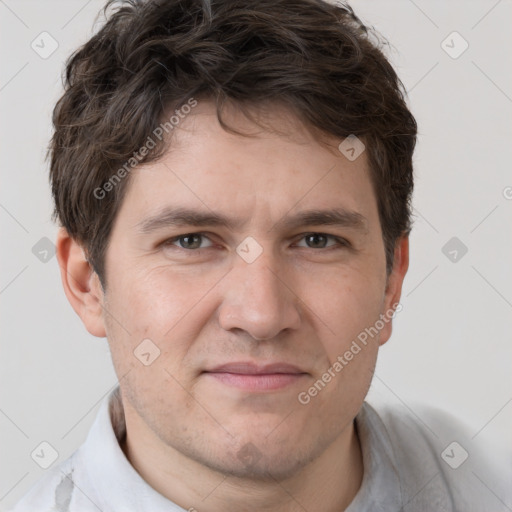 Joyful white adult male with short  brown hair and grey eyes