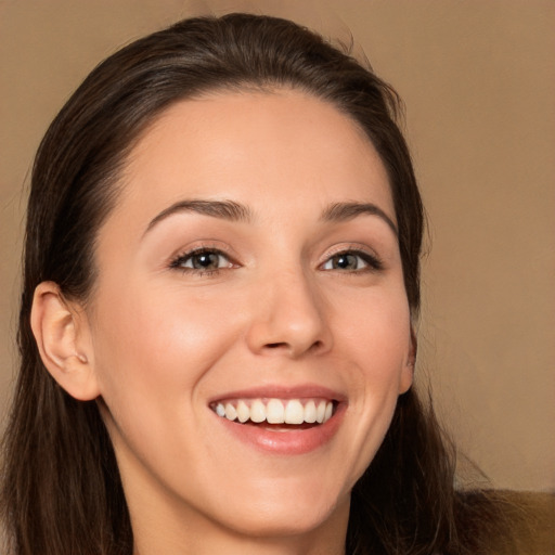 Joyful white young-adult female with long  brown hair and brown eyes