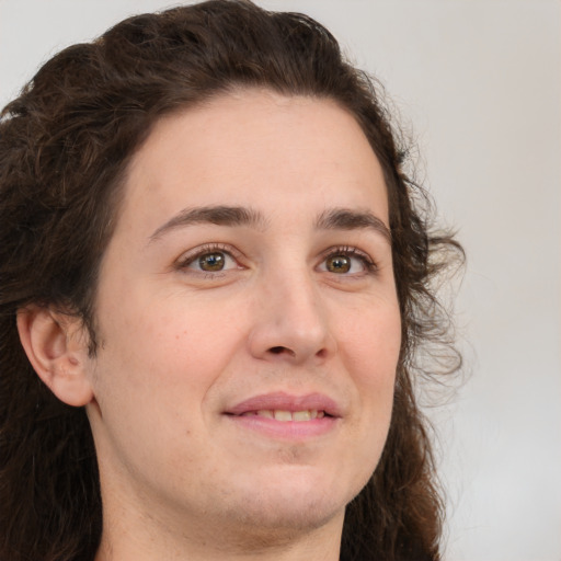 Joyful white young-adult female with long  brown hair and green eyes