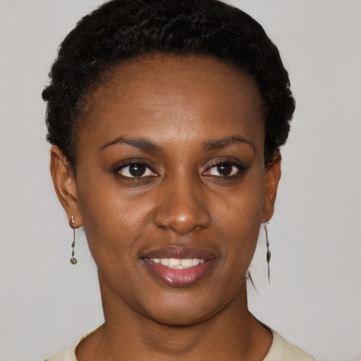 Joyful black young-adult female with short  black hair and brown eyes