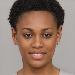 Joyful black young-adult female with short  brown hair and brown eyes