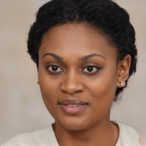 Joyful black young-adult female with medium  black hair and brown eyes
