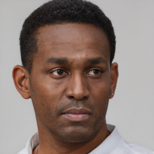 Neutral black young-adult male with short  black hair and brown eyes