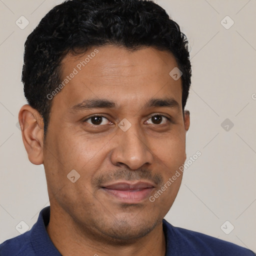 Joyful latino young-adult male with short  brown hair and brown eyes