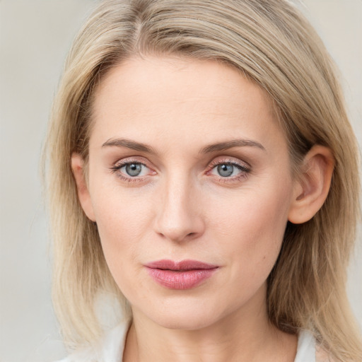 Joyful white young-adult female with medium  brown hair and blue eyes