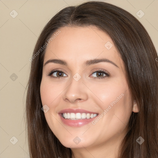 Joyful white young-adult female with long  brown hair and brown eyes