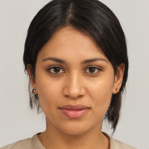 Joyful latino young-adult female with medium  brown hair and brown eyes